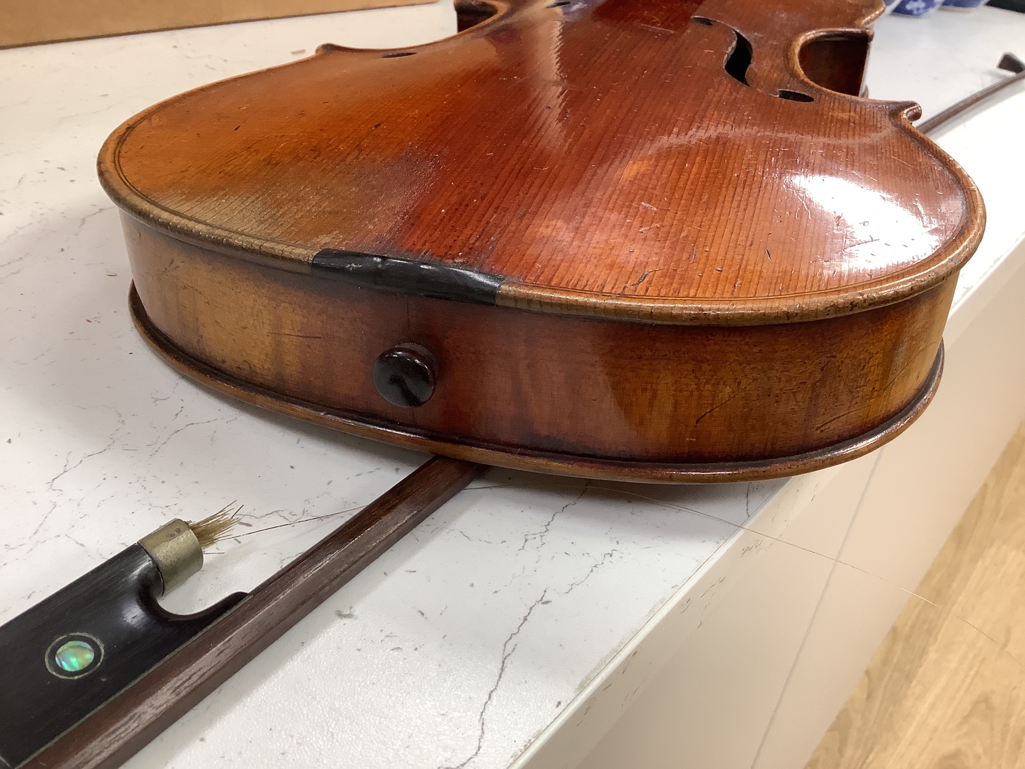 A Lowendall violin, labelled Stradivarius, 58cm long, together with a bow